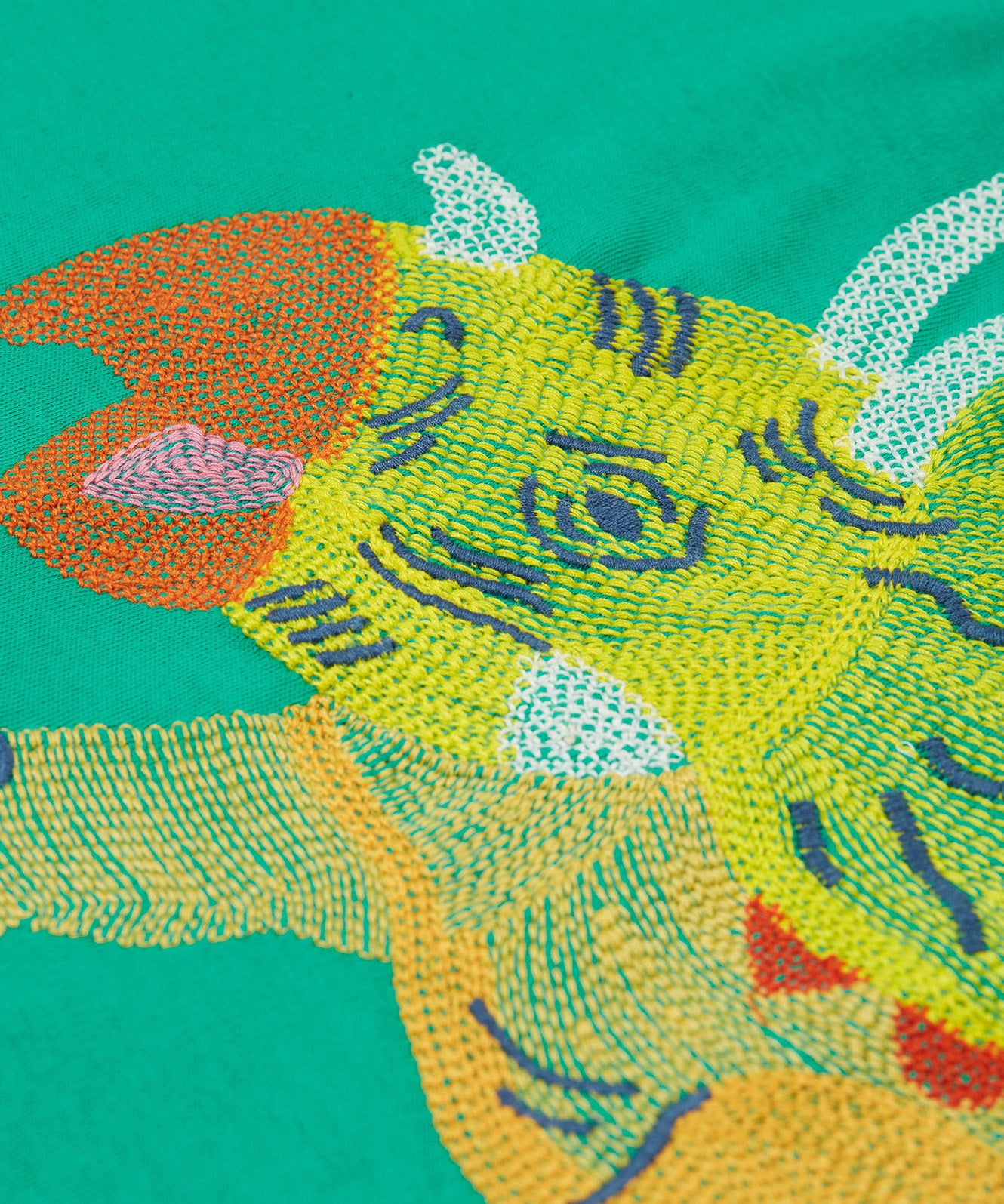 Frugi kids green stop in a green colour with a triceratops design embroidery detail