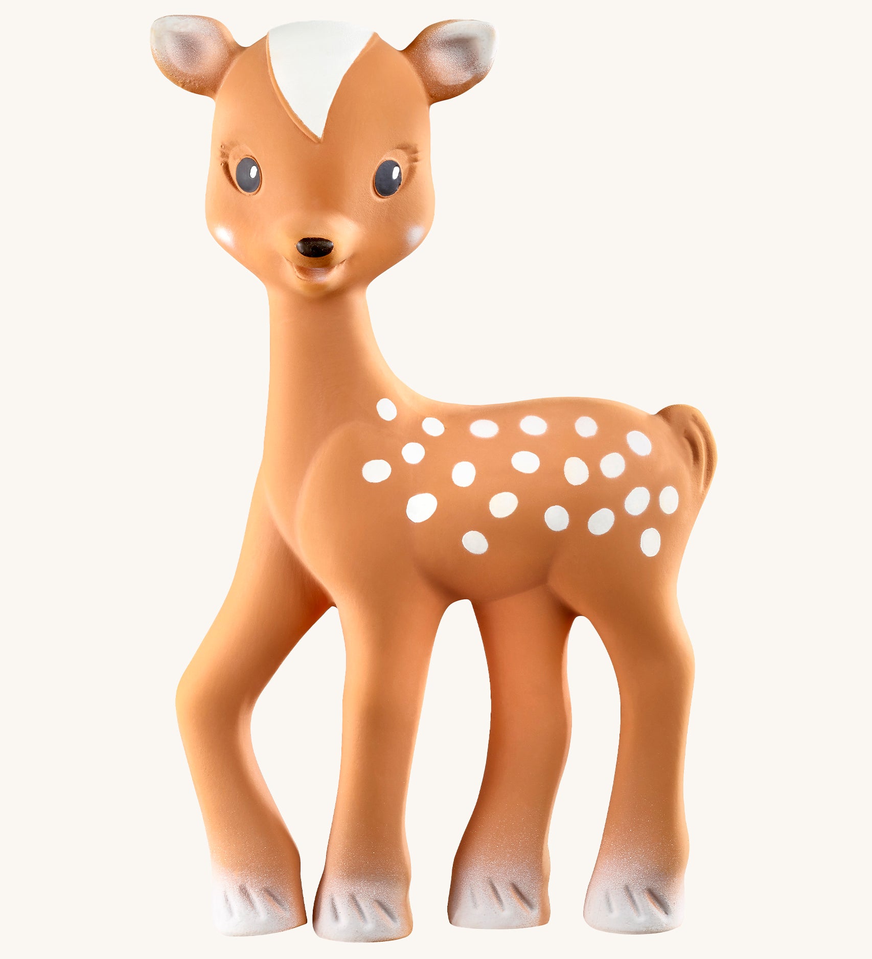 Fanfan The Fawn Baby Teether, is a natural rubber teething toy in light brown with white hooves, white spots white tipped ears and a white triangular section on top of its head. The image is on a cream background