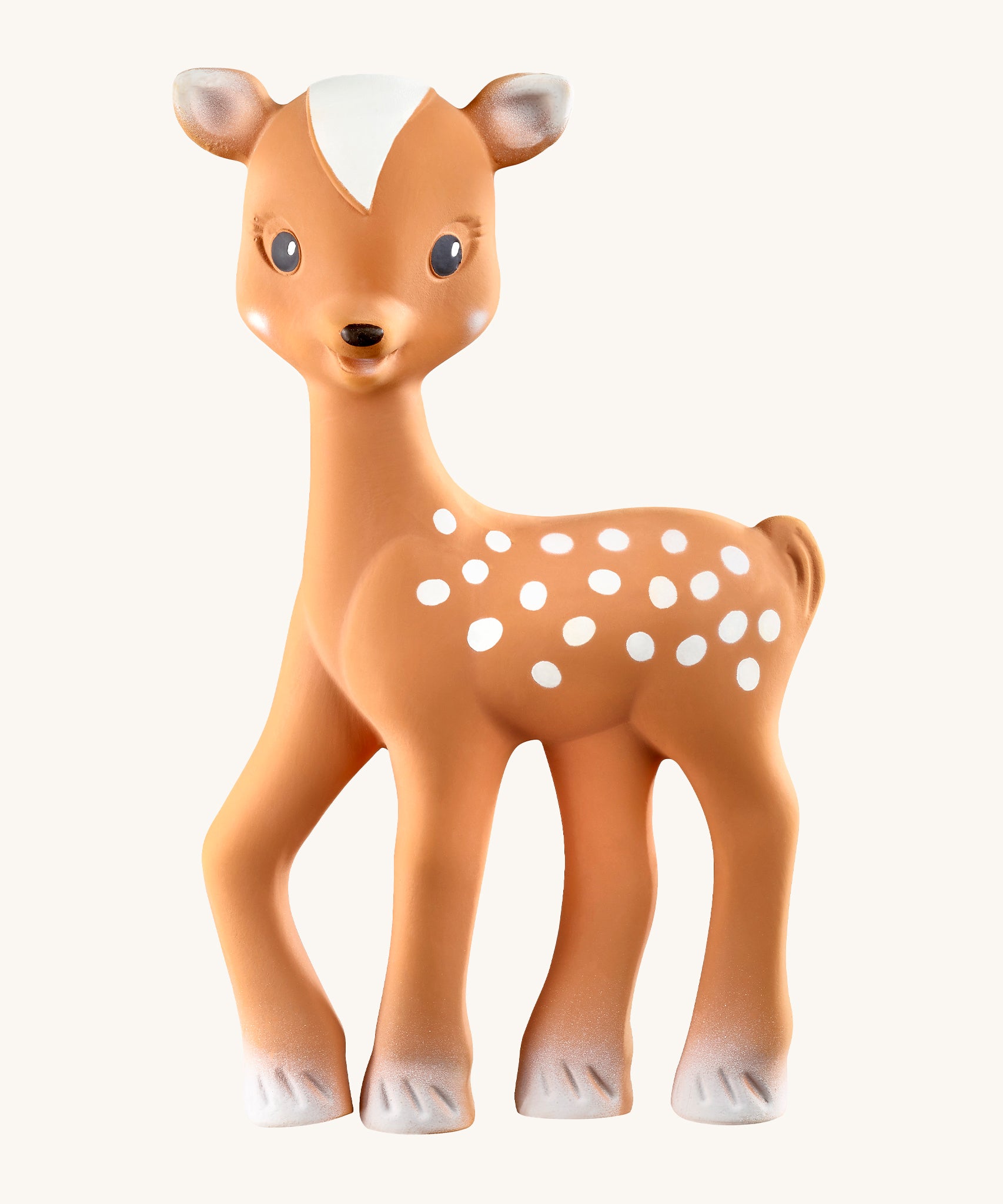 Fanfan The Fawn Baby Teether, is a natural rubber teething toy in light brown with white hooves, white spots white tipped ears and a white triangular section on top of its head. The image is on a cream background