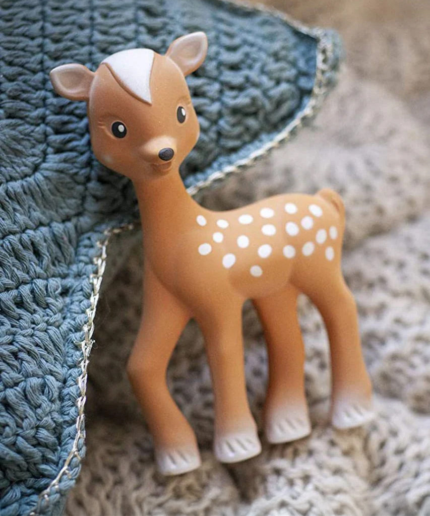 Fanfan The Fawn Baby Teether, laid on a blue and cream knitted blanket 