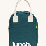 Fluf zip lunch bag in a teal blue colour with lunch printed on the front in white with a white handle and zip detail on a cream background.