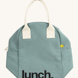 Fluf zip lunch bag in a light pastel blue colour laid flat with a white handle and lunch logo on the bottom on a cream background.