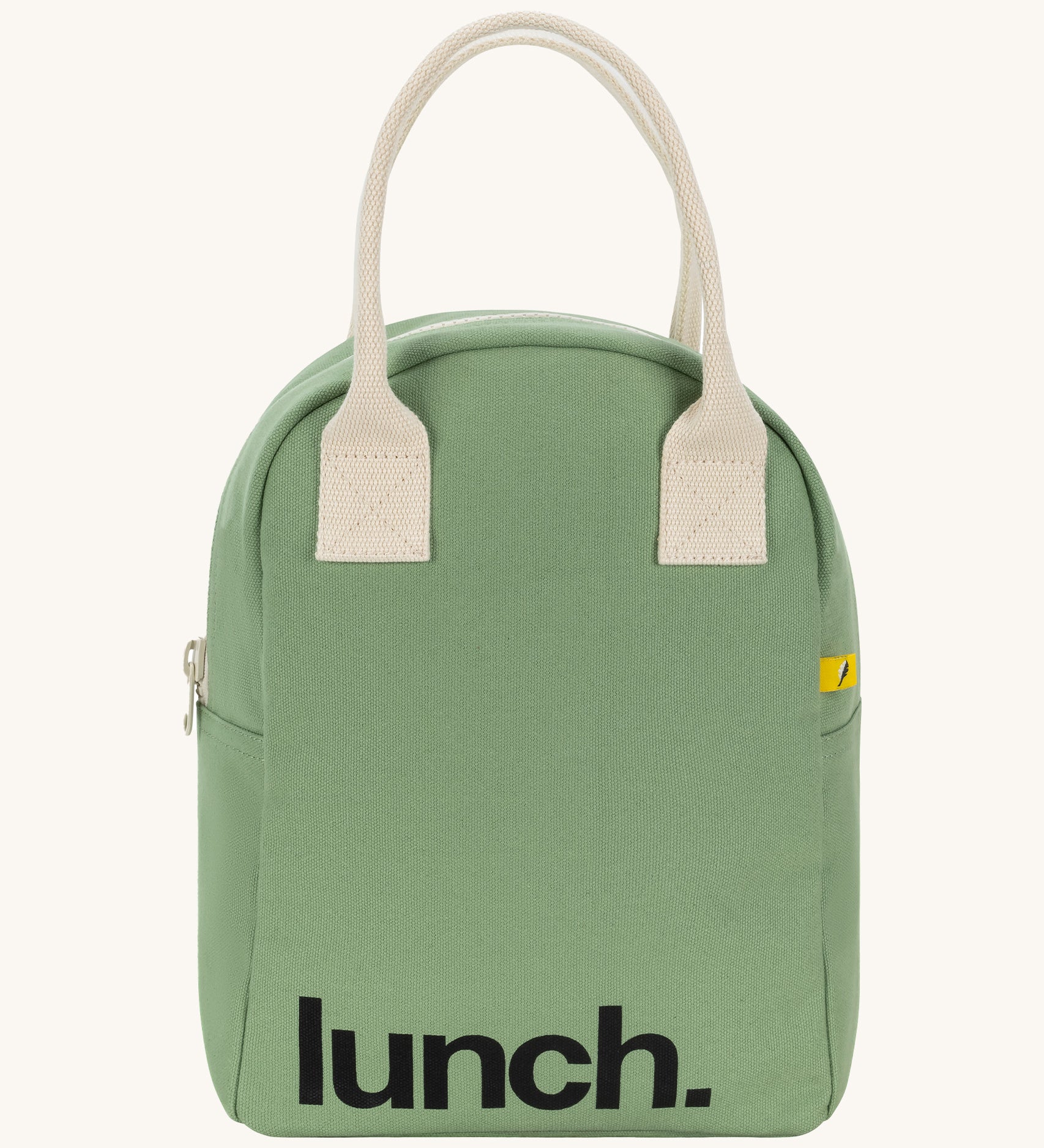 Fluf zip lunch bag in a light pastel green colour with a white handle and lunch logo on the bottom on a cream background.