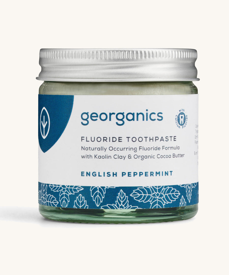 A jar of the english peppermint Georganics fluoride toothpaste on a cream background