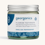 A jar of the english peppermint Georganics fluoride toothpaste on a cream background