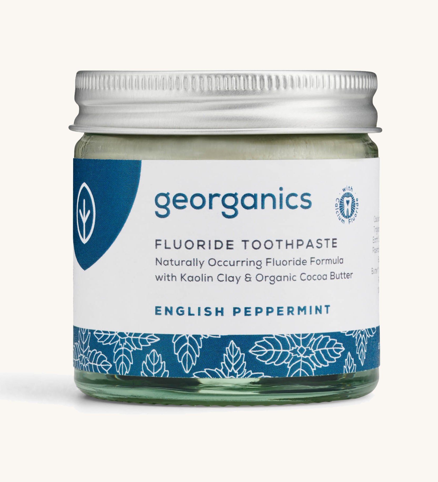 A jar of the english peppermint Georganics fluoride toothpaste on a cream background