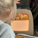 A child putting a Toverlux Magic Lamp silhouette inside the Magic Lamp.