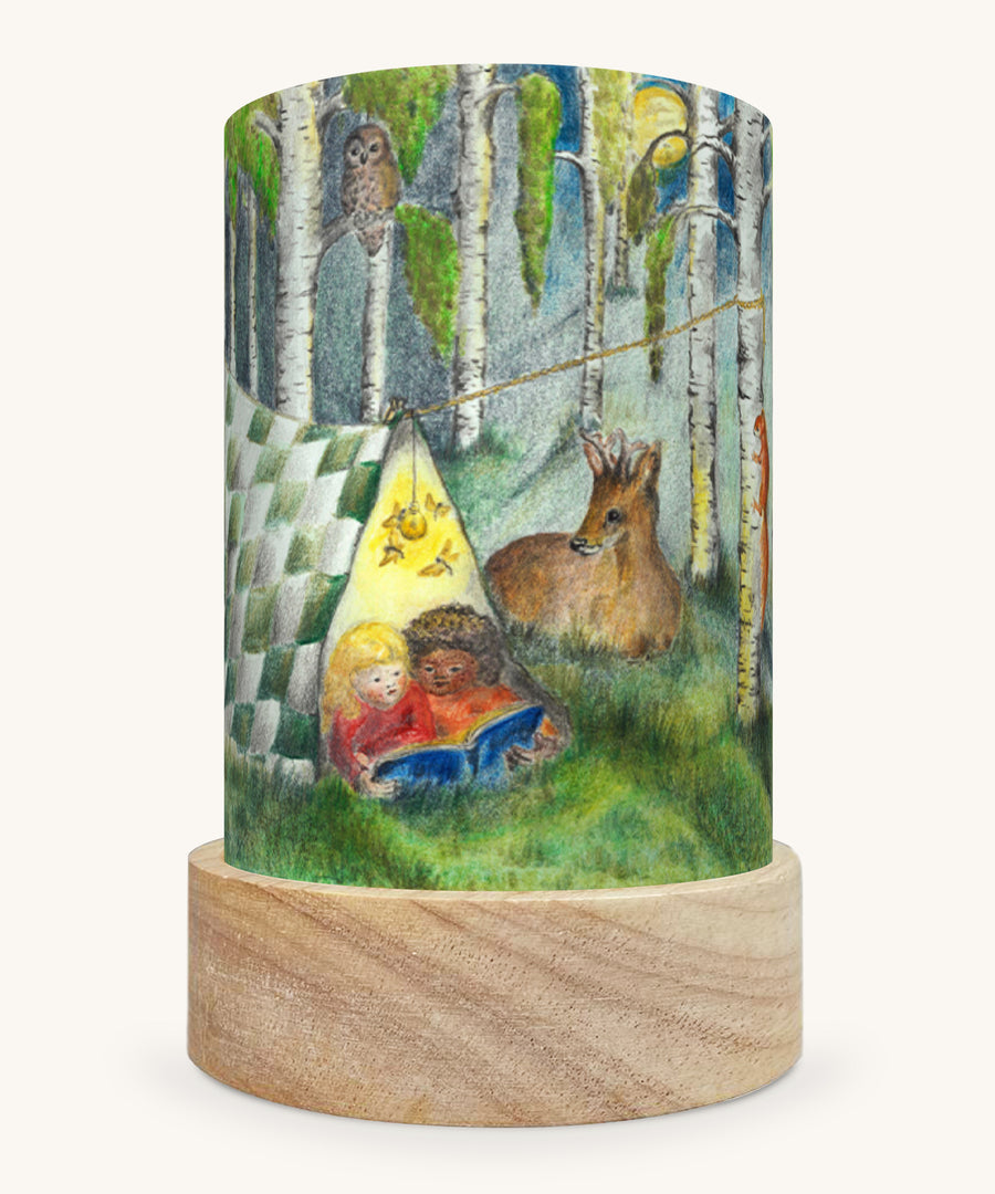 The Forest Whispers illustration by Eentje Van Margo sat in a Toverlux Magic Lantern base, on a cream background