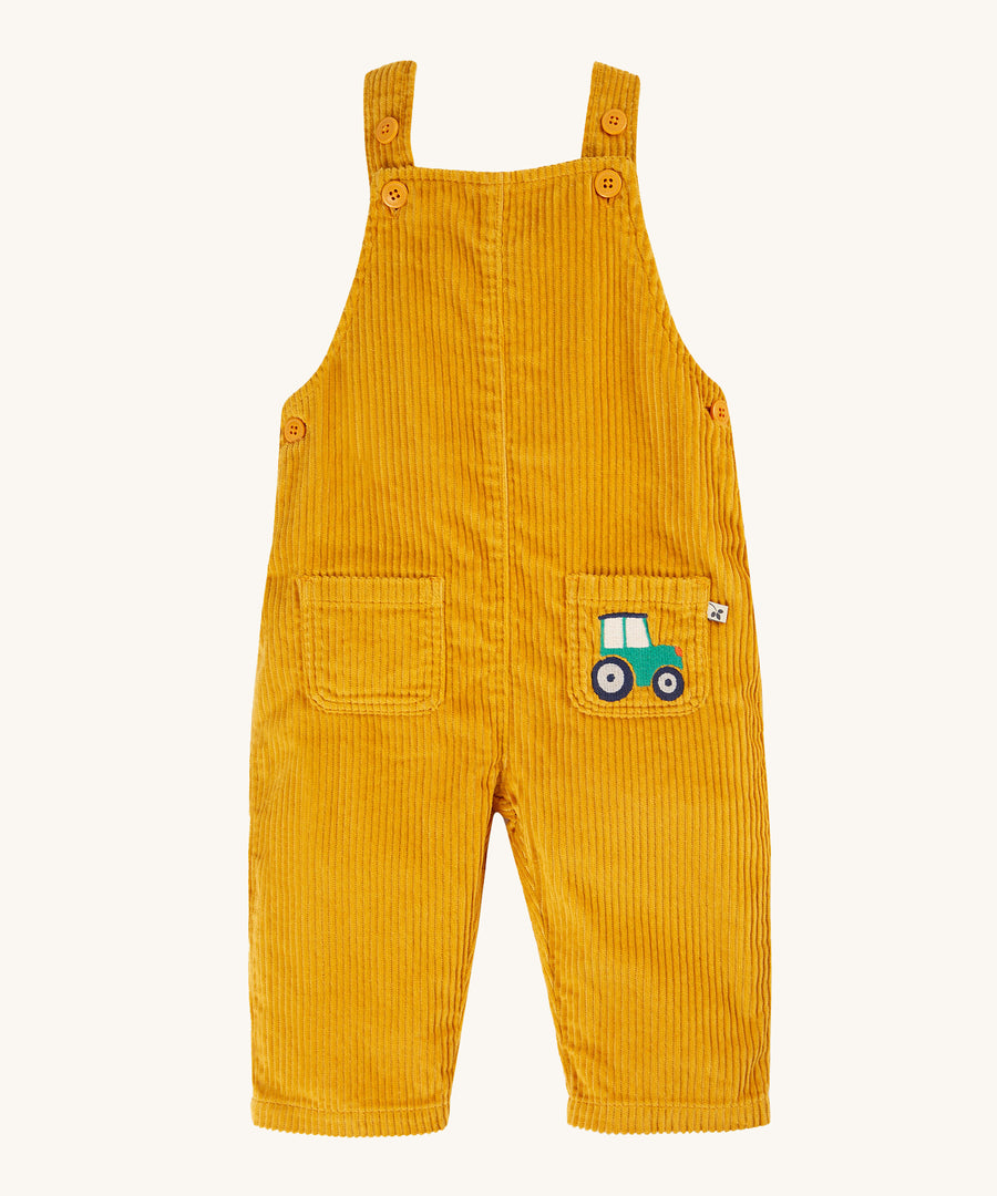 Frugi Adley Cord Dungarees - Gold/Tractor. Yellow cord dungarees with an embroidered tractor on the front pocket