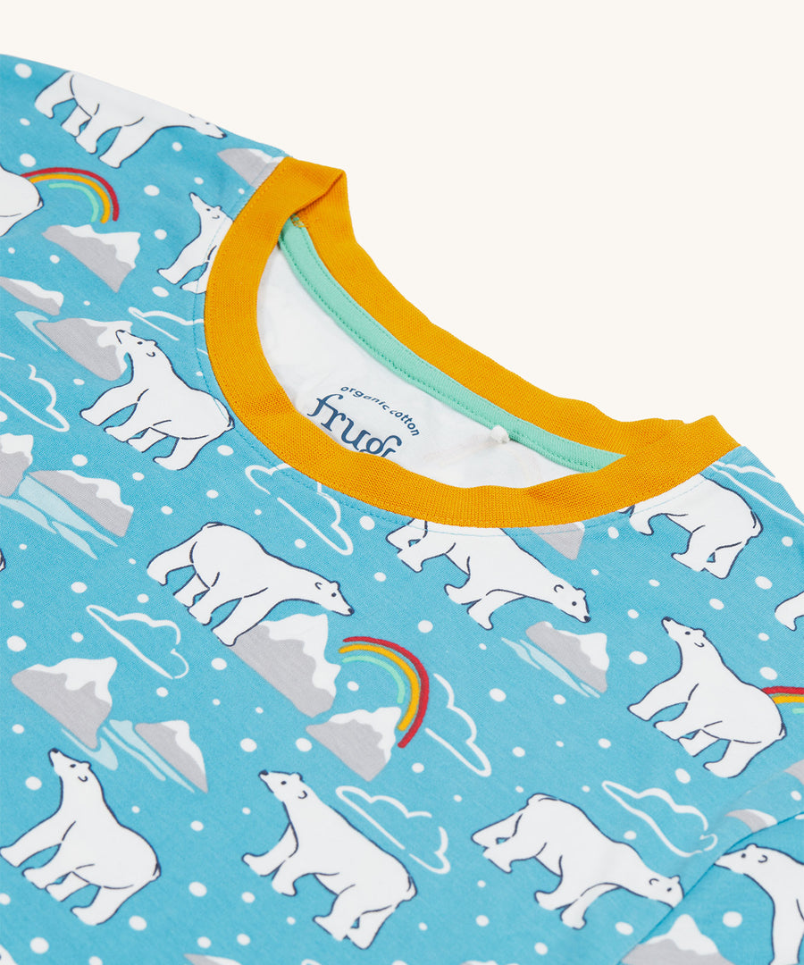 A closer look at the yellow neck detail on the Frugi Adult Penzance Pyjamas - Winter Tails. The image also shows the polar bear design with icebergs and rainbows on the top