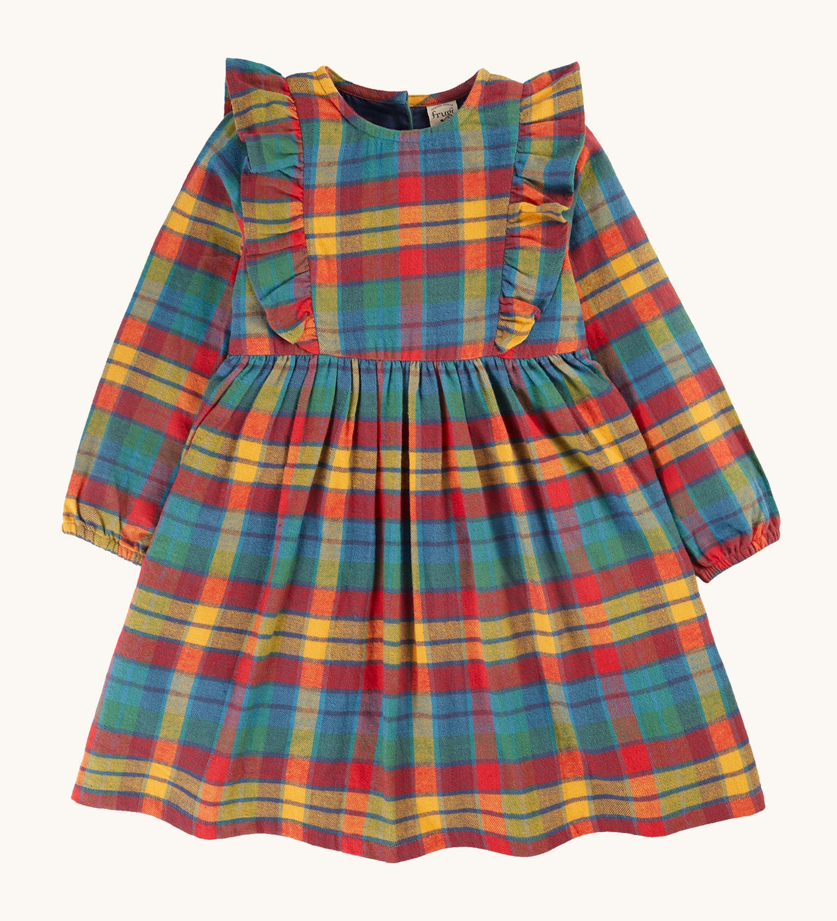 Frugi Agnes Dress - Merry Rainbow Check. An organic cotton dress, with long sleeves and, frilly detailing. In a rainbow check print in shades of red, yellow, green and blue