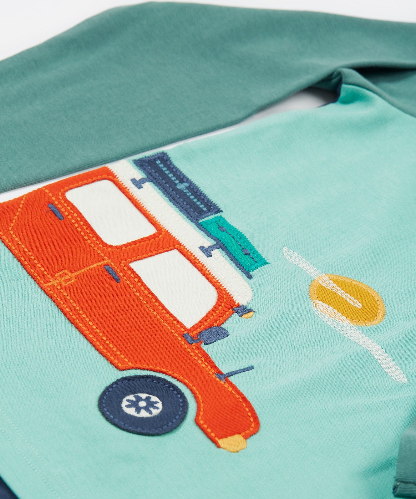 A closer look at the car applique on the front of the Frugi Albert Wrap Around Top - Moss/4X4 Camper