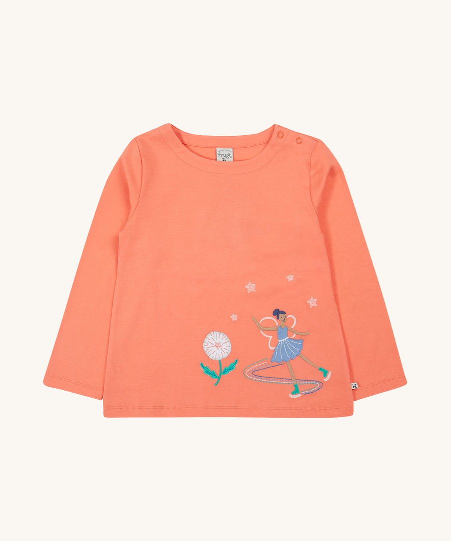 Frugi Anna Applique Top - Cantaloupe/Fairy. Made from orgaic cotton, this long-sleeved Anna Appliqué Top from Frugi, in Cantaloupe, has a Fairy appliqué on the front