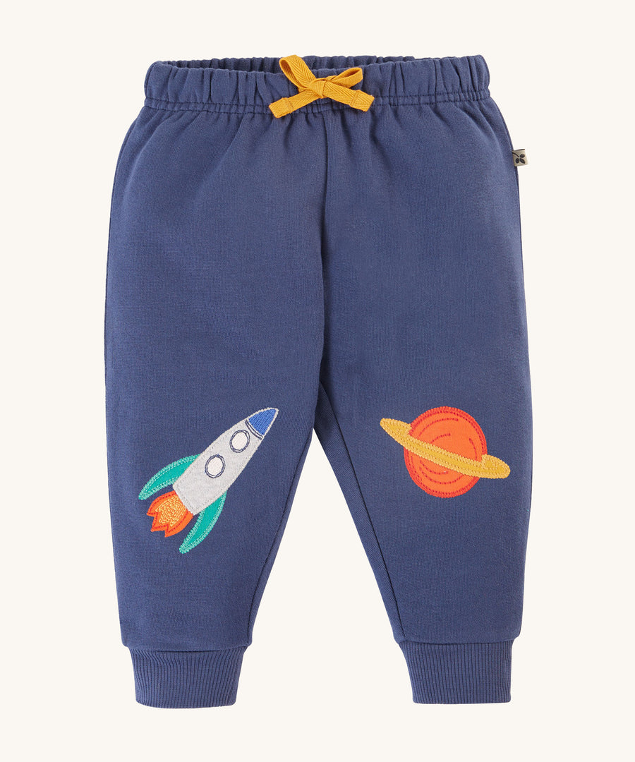 Frugi Character Crawlers - Navy Blue/Rocket. Made from soft and durable organic cotton, with a Rocket and Planet appliqué on the knees. In Navy Blue, with an elasticated waistband and a yellow drawcord