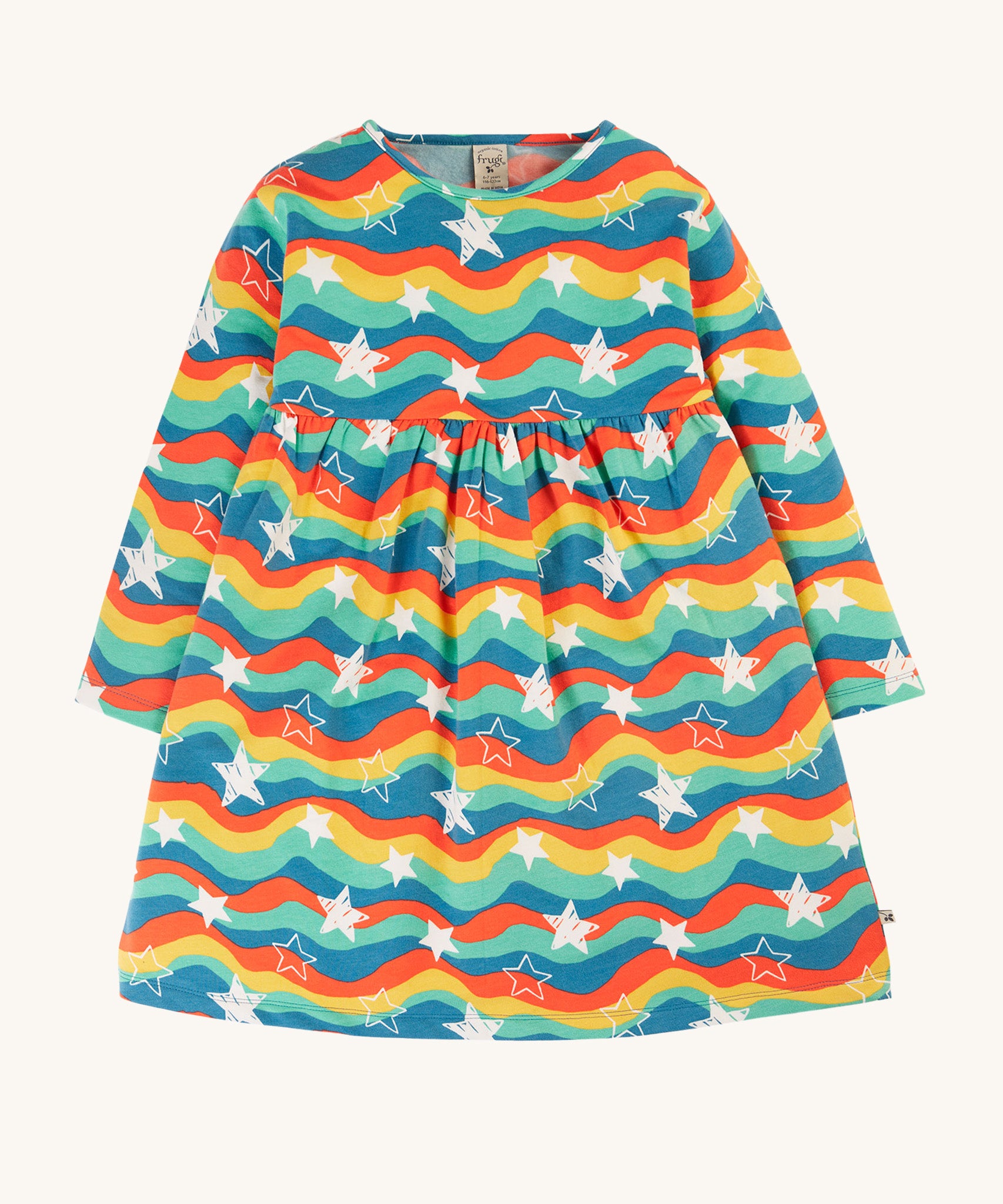 This long-sleeved Amelia Dress from Frugi is made from super soft, lightweight and stretchy brushback fleece, perfect for keeping kids comfy and warm during any adventure. In Wavy Stars print, this kids' dress has gathers around the waist and poppers on the back for easy dressing.