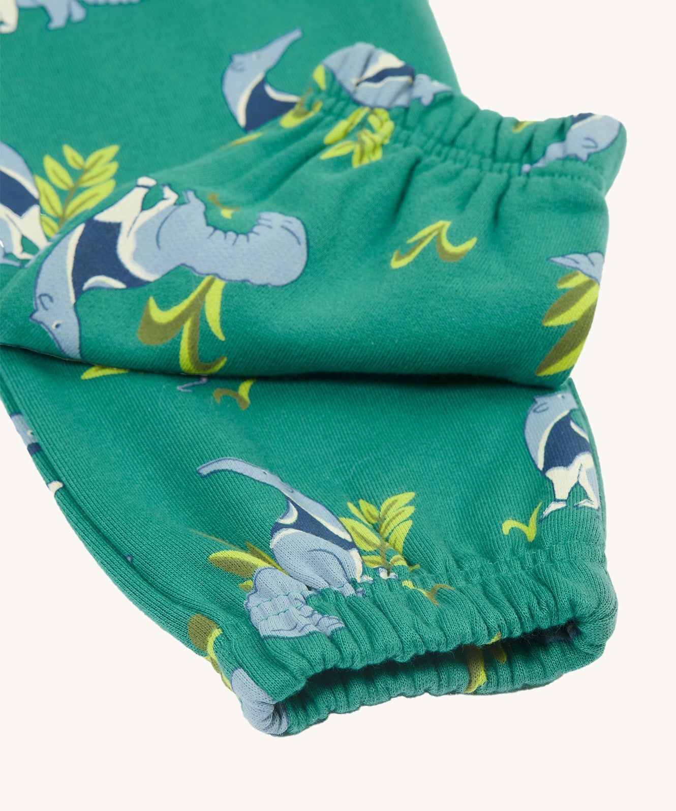 A closer look at the elasticated ankle cuffs on the Frugi Malpas Joggers - Anteater Parade. Also shown is the green fabric and repeat anteater print