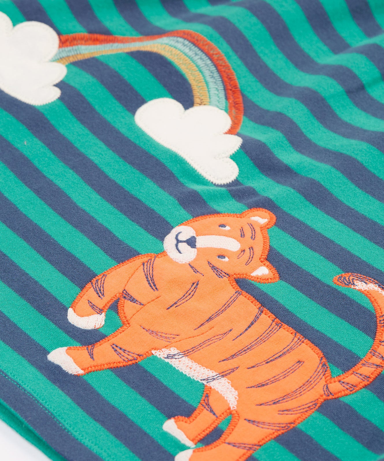 A closer look at the tiger and rainbow detail on the Frugi Dolcie Dress - Iguana Stripe/Tiger