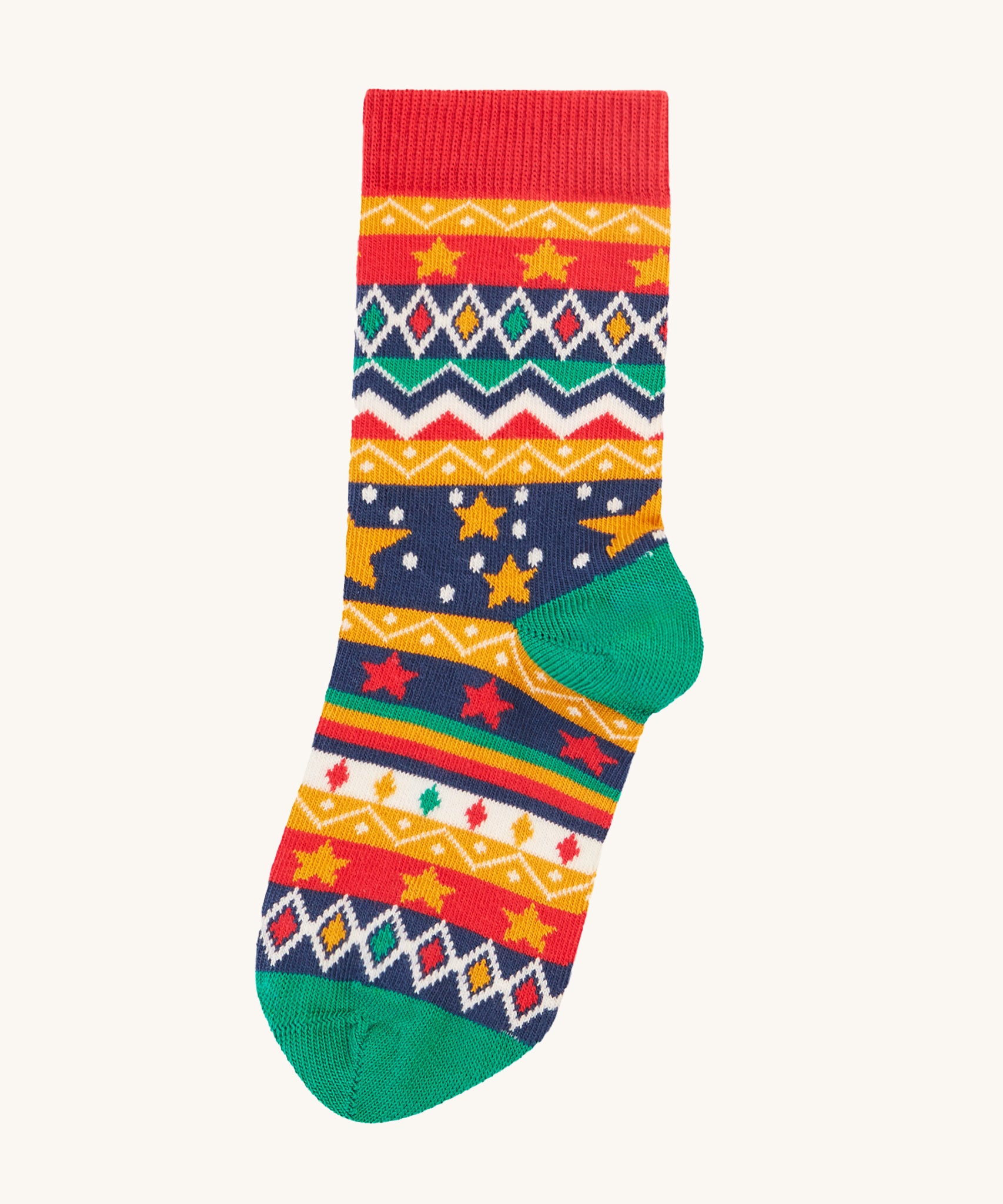 A closer look at the festive star print socks, from the Frugi Rock My Socks - Bear 3 Pack. The sock has different patterns such as diamonds, zig-zags, stars and bold stripes, in red, yellow, blue, green and white