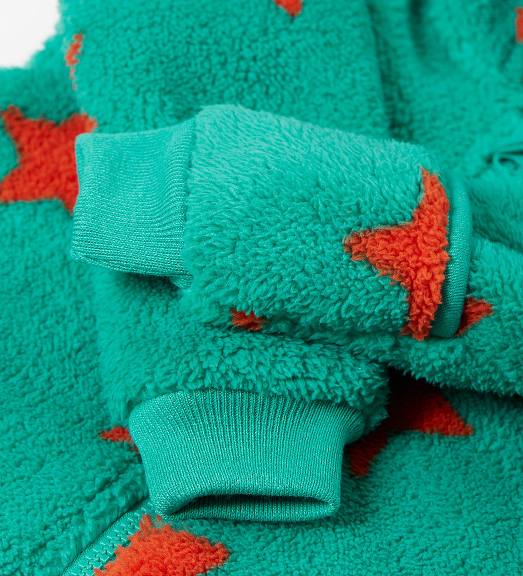 A closer look at the wrist cuffs on the Frugi Cosy Ted Snuggle Suit - Bonfire Stars