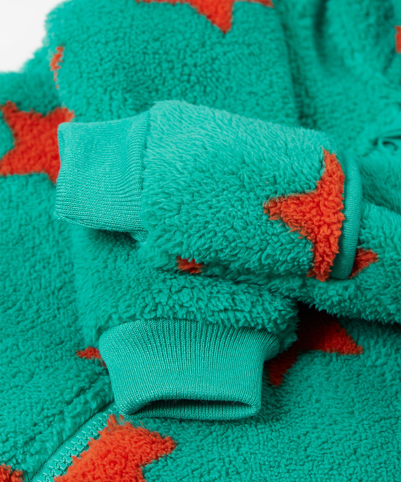 A closer look at the wrist cuffs on the Frugi Cosy Ted Snuggle Suit - Bonfire Stars