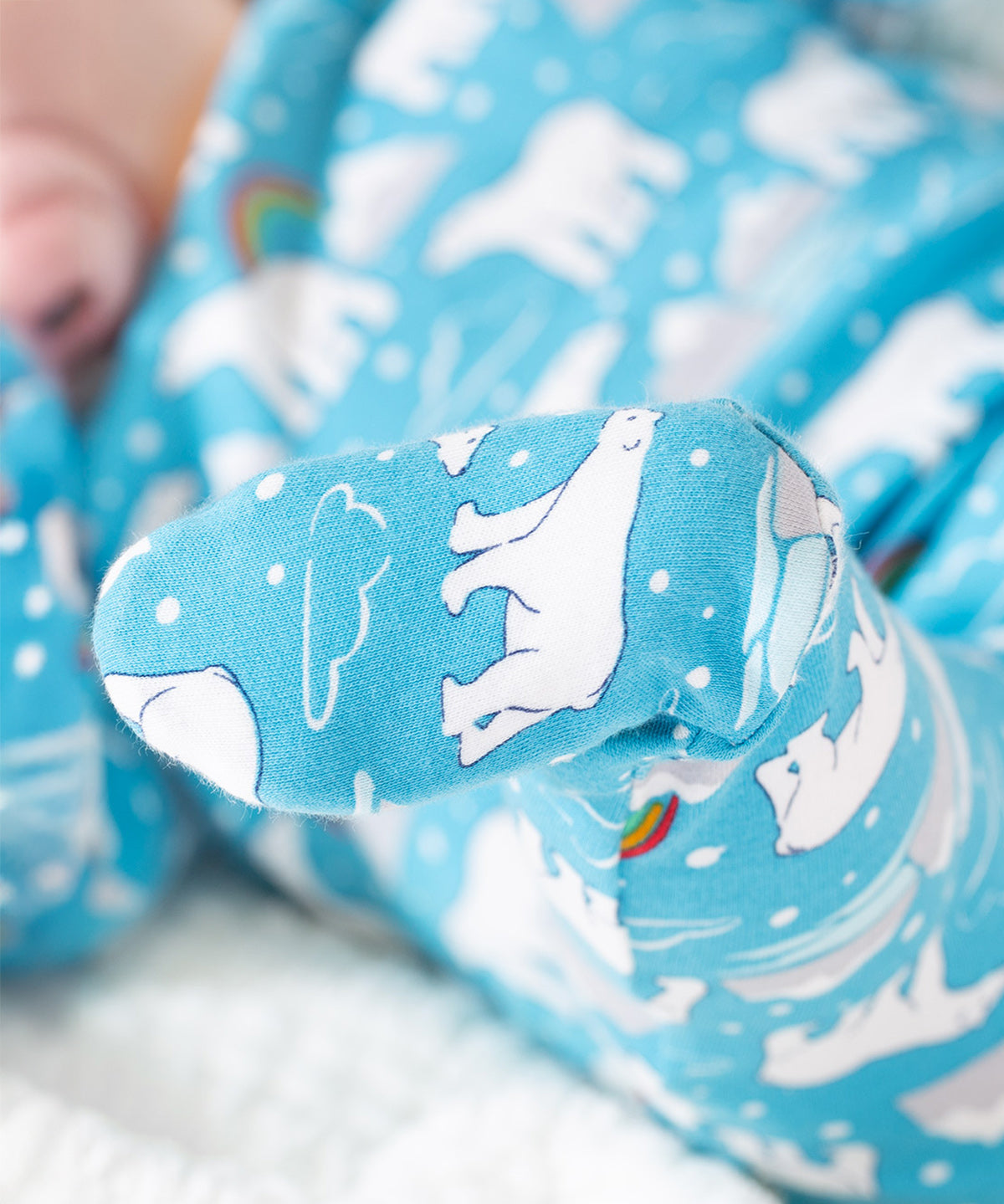 The foot of the Frugi Easy Dressing Babygrow - Winter Tails, fully covering the toes to keep them nice and warm. The polar bear print is also on the bottom of the feet