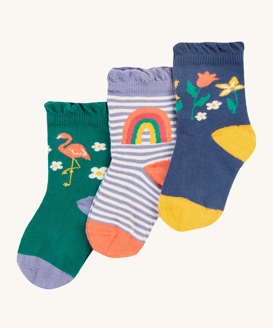 Frugi Freya Frilled Socks 3 Pack - Rainforest Friends. Organic Cotton frill socks in lovely 'Rainforest Friends' designs, one pair comes in navy with delicate flowers and yellow heels and toes, one green pair features a flamingo with lilac heels and cuffs, and the other comes in a lilac stripe with a rainbow on the ankles