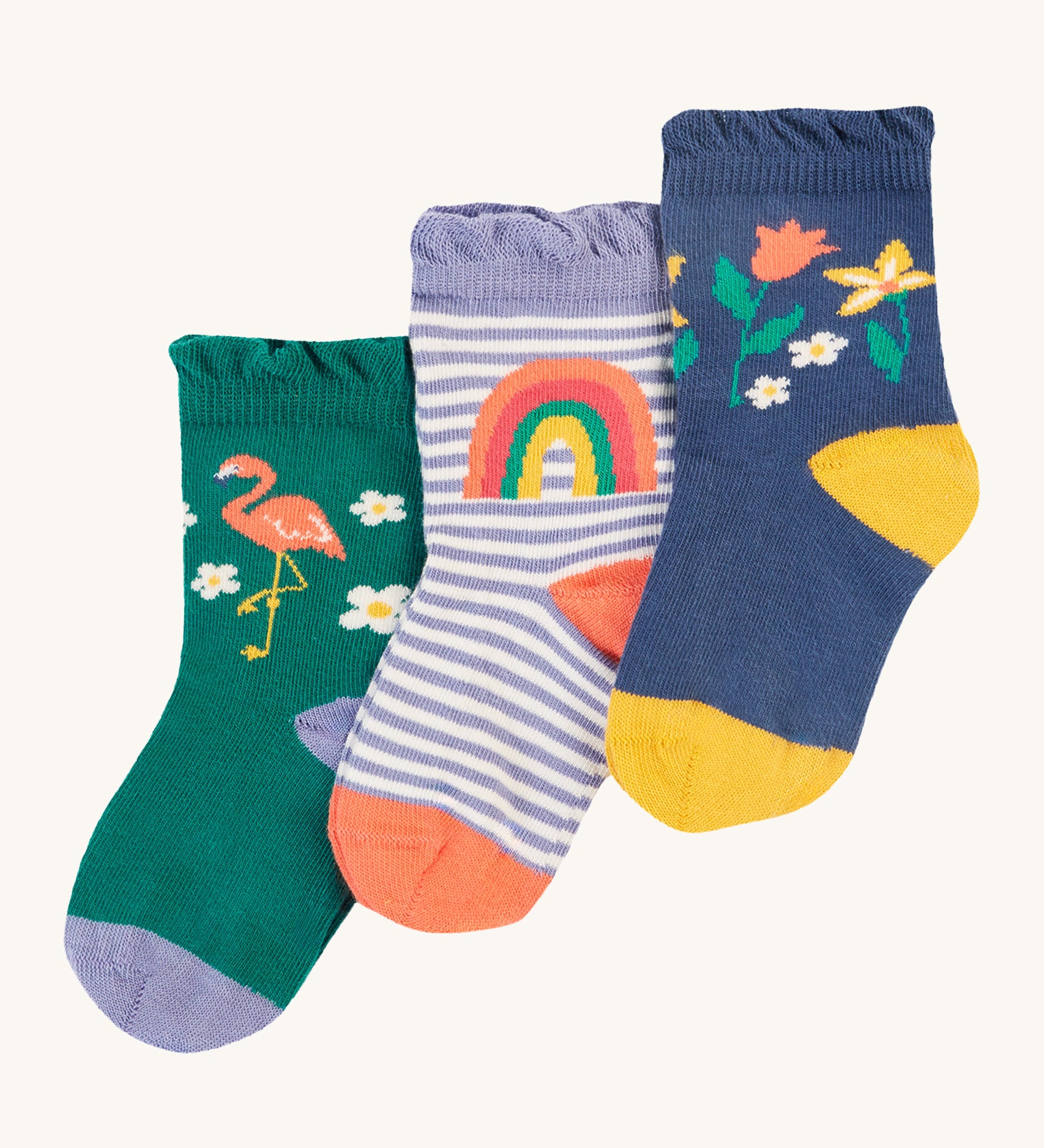 Frugi Freya Frilled Socks 3 Pack - Rainforest Friends. Organic Cotton frill socks in lovely 'Rainforest Friends' designs, one pair comes in navy with delicate flowers and yellow heels and toes, one green pair features a flamingo with lilac heels and cuffs, and the other comes in a lilac stripe with a rainbow on the ankles