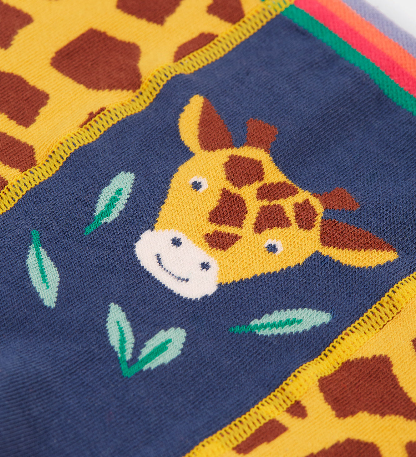 A closer look at the giraffe print on the front of the Frugi Little Knitted Leggings - Giraffe