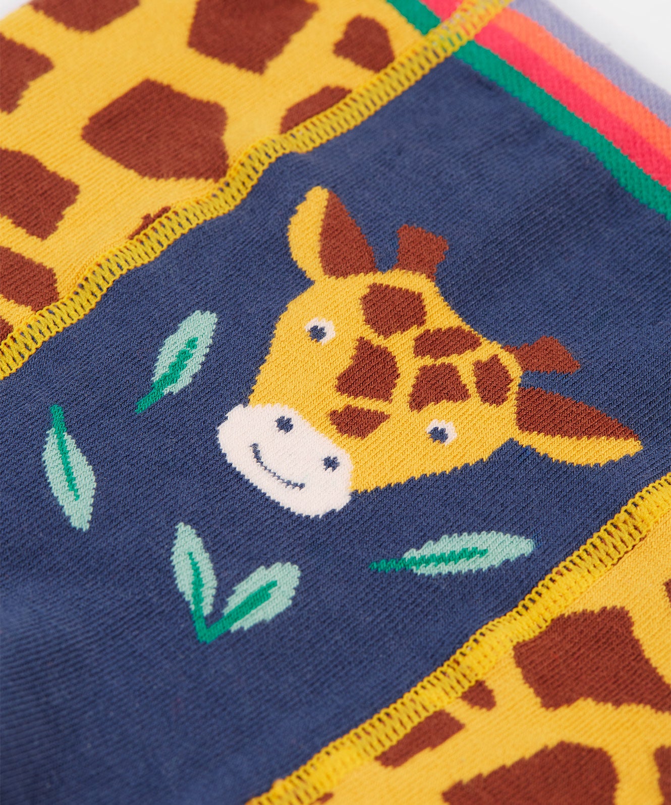 A closer look at the giraffe print on the front of the Frugi Little Knitted Leggings - Giraffe