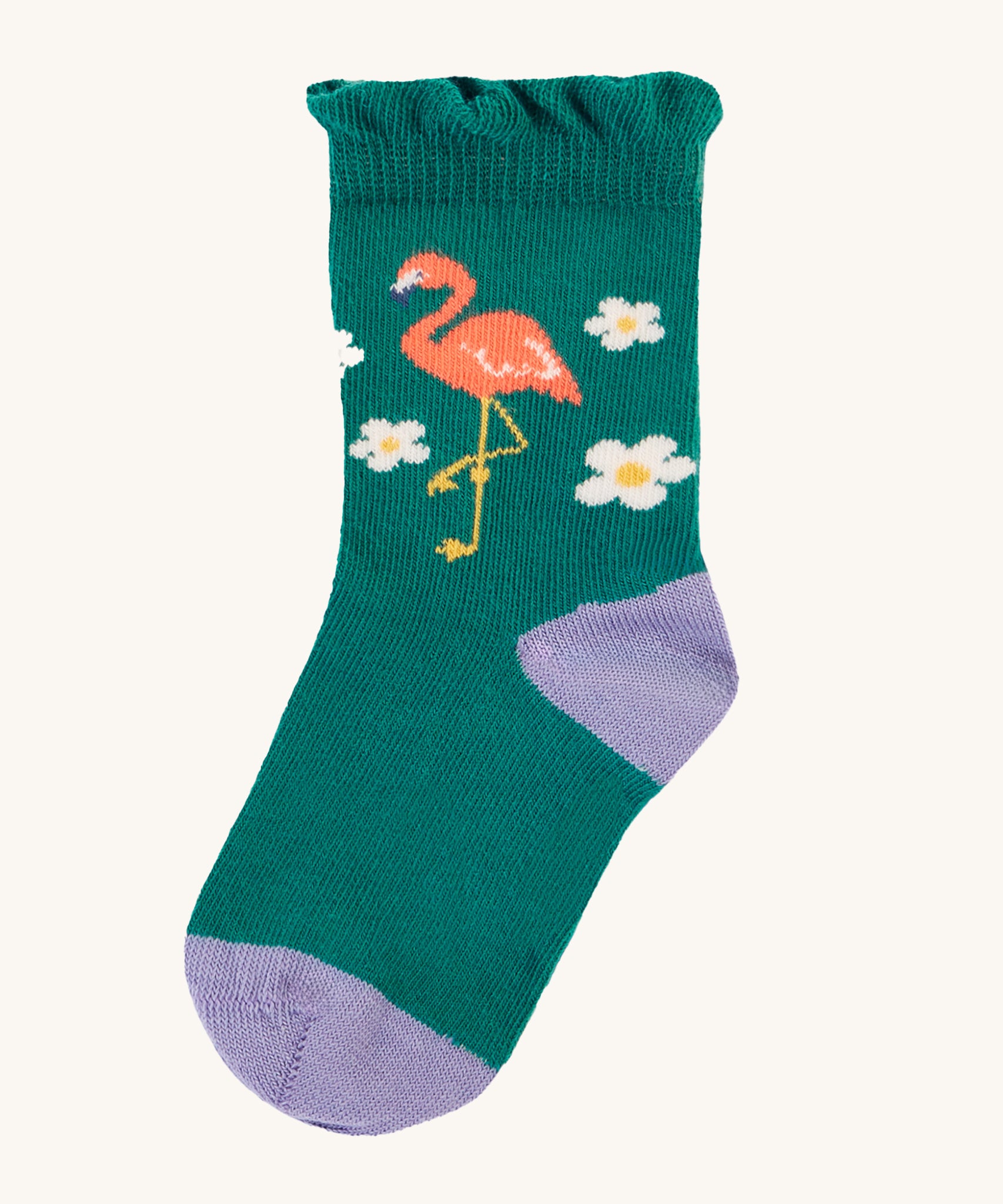 The green socks from the Frugi Freya Frilled Socks 3 Pack - Rainforest Friends. This sock has a lilac toe and heel, white flowers and a flamingo on emerald green fabric