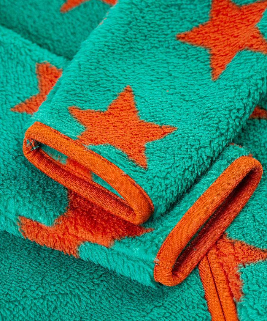 A closer look at the cuffs on the Frugi Zipped Ted Fleece Jacket - Bonfire Stars, showing the green fleece, orange stars and piping