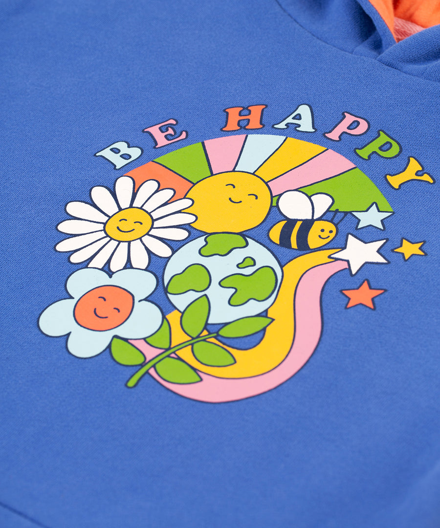 A closer look at the Be Happy print on the front of the Frugi Lissie Oversized Hoodie - Blue Tang/Be Happy. This includes a bee, planet earth, a plant, a rainbow, smiling flowers and a smiling sun with the words "Be Happy" above on soft, blue fabric.