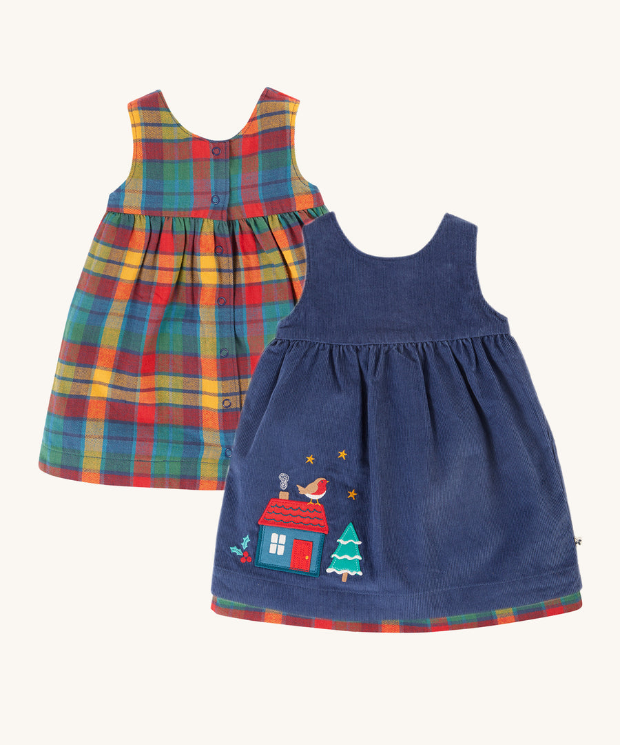 Frugi Inara Cord Reversible Dress - Navy Blue/Rainbow Check. A beautiful Navy Blue, corduroy dress with a festive house and robin applique detail on one side, and the other side is a rainbow check print