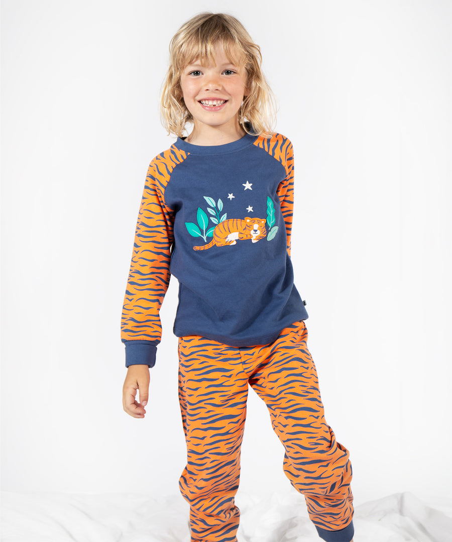 A child wearing the Frugi Jamie Jim Jams - Sleeping Tiger