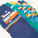 A closer look at the designs on the Frugi Rock My Socks 3 Pack - Alpine Adventures. The one showing at the front is a navy blue sock with a night time camper van print