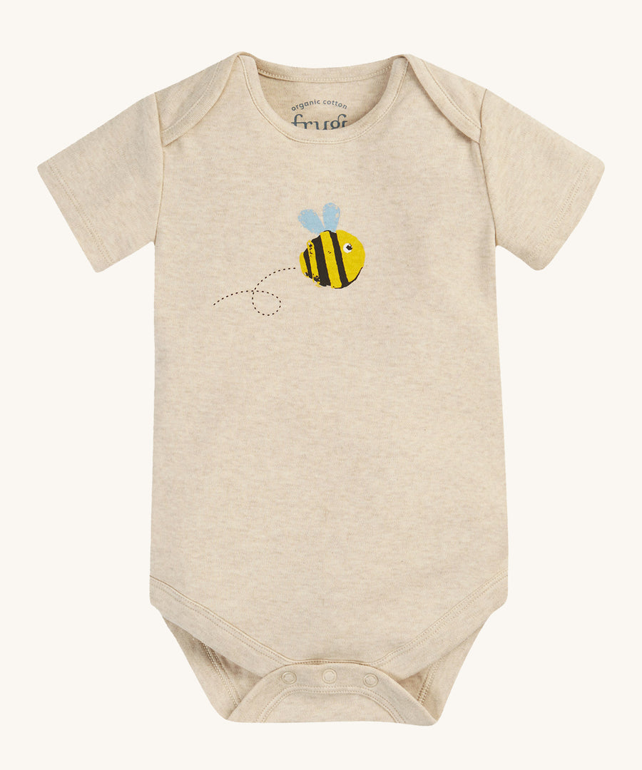 The short sleeve bodysuit from the Frugi Baby Muslin Gift Set - Buzzy Bee. A dark cream cotton fabric, with a buzzy bee print on the front