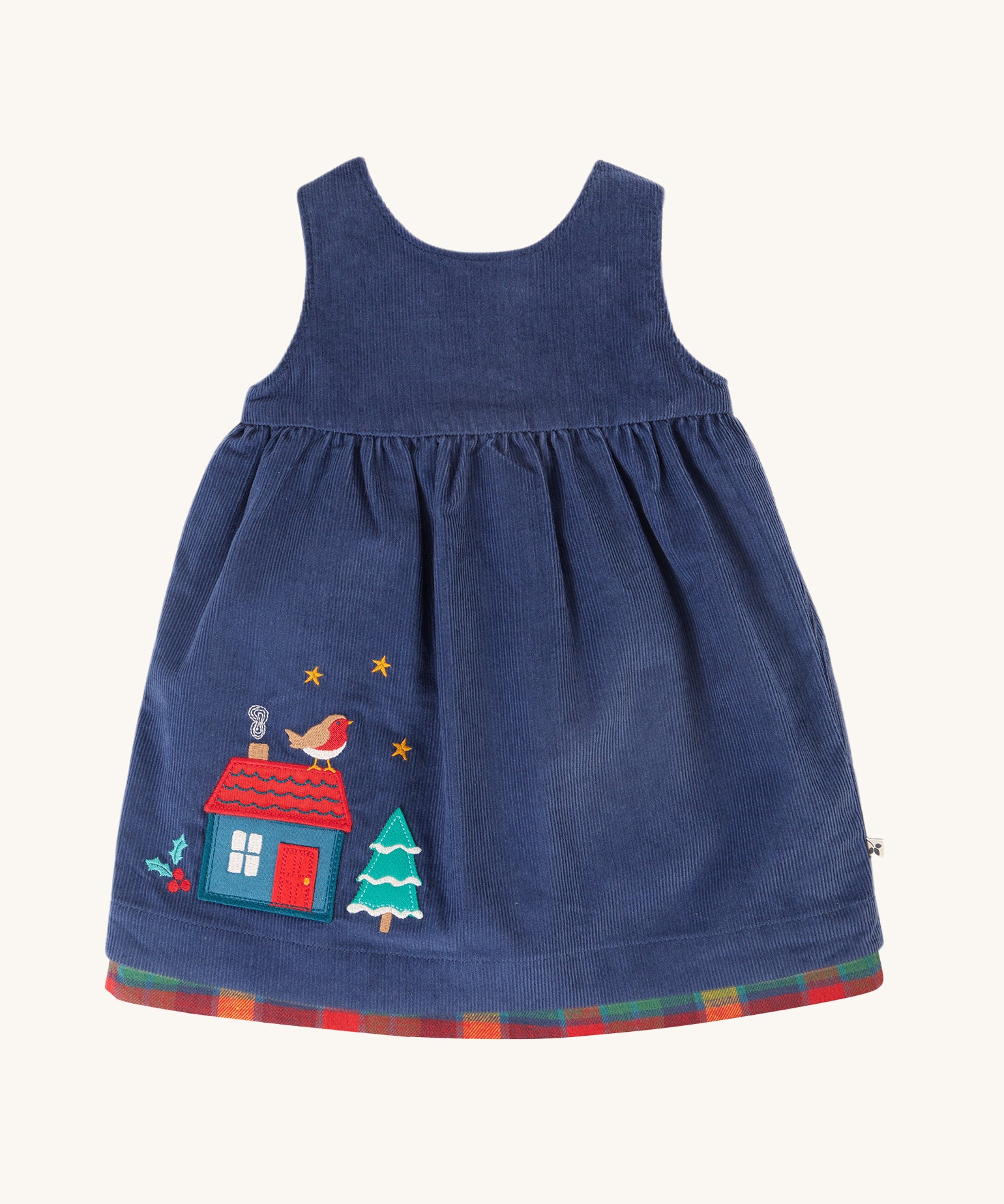 The navy blue corduroy side of the Frugi Inara Cord Reversible Dress - Navy Blue/Rainbow Check. The image shows the house, robin and snowy tree applique