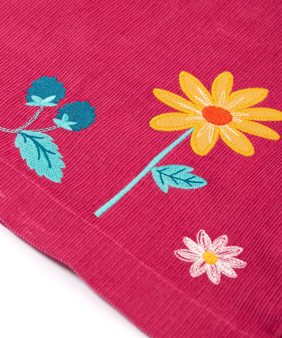 A closer look at the embroidered flower detail on the Frugi Coco Cord Dress - Lingonberry/Squirrel