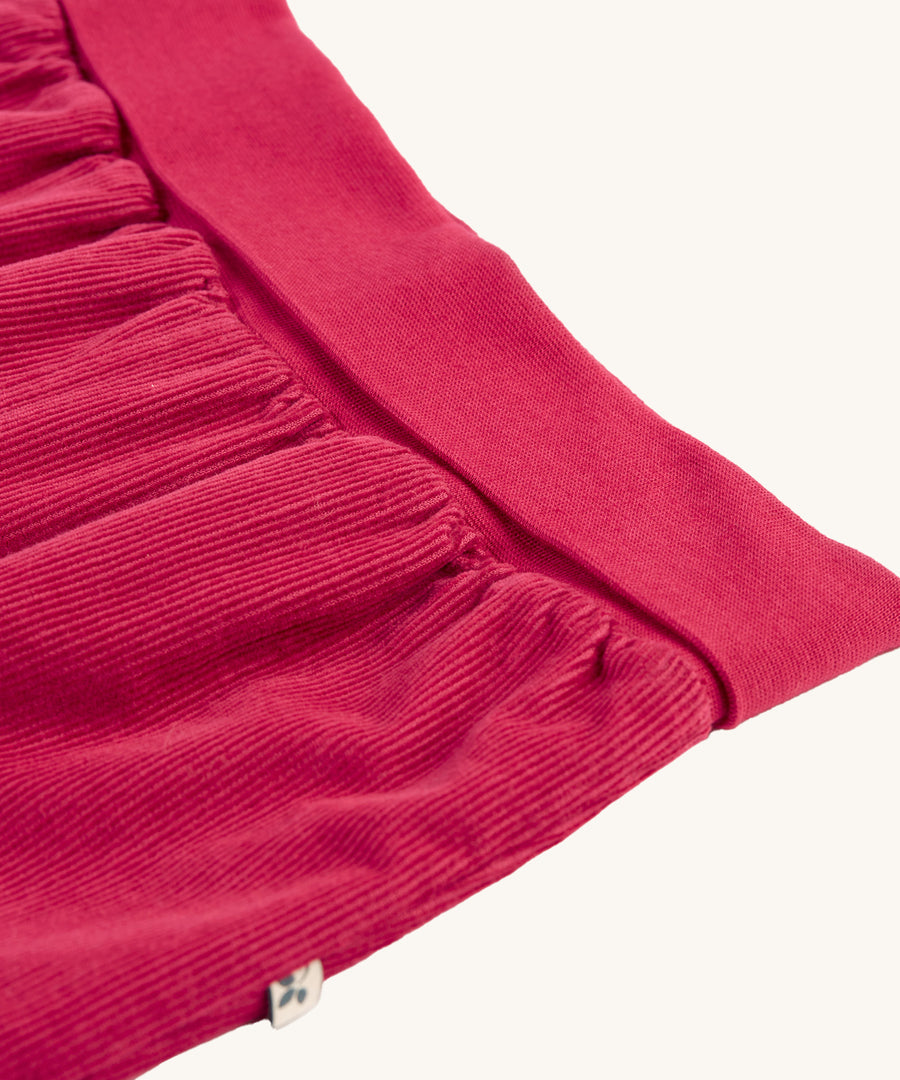 A closer look at the waistband and cord detail of the Frugi Carrot Cord Pull Ups - Lingonberry