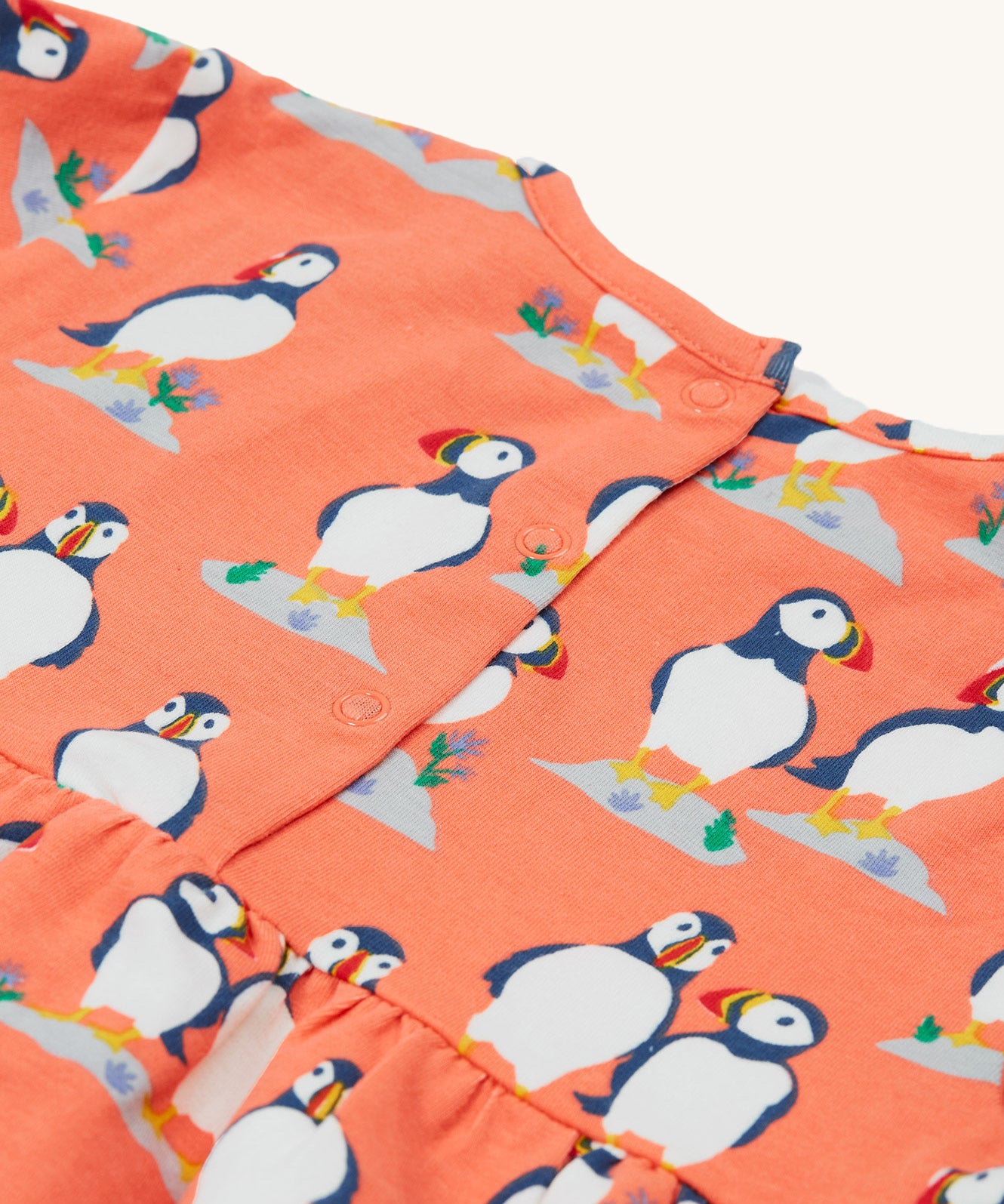 A closer look at the popper fasteners on the Frugi Dee Dress - Puffin Pals