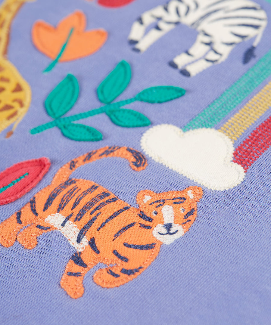 A closer look at the tiger applique with embroidered details, on the Frugi Ria Hoodie Dress - Grape/Stay Wild. Also shown is a small cloud with the start of the rainbow, applique leaves and the legs of the zebra