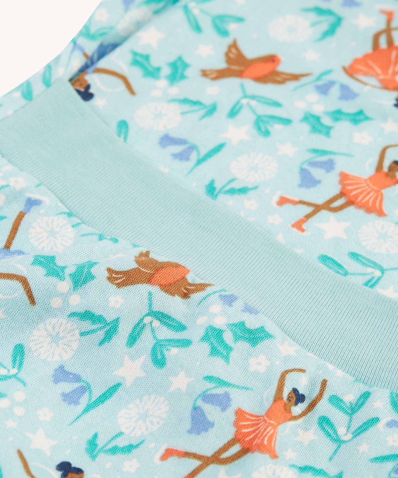 A closer look at the elasticated rib band n the back of the Frugi Easy Dressing Printed Babygrow - Enchanted Forest, for easy on dressing