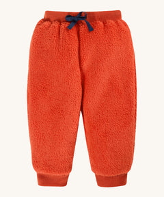 Frugi Ted Fleece Pull Ups - Bonfire. A fluffy pair of pull up trousers in orange with a blue drawstring at the waist