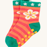 The flower print of the Frugi Grippy Socks 2 Pack - Giraffe. Showing the yellow grippy dots at the bottom of the socks