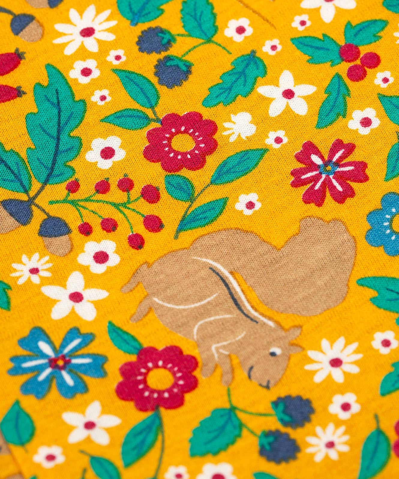 A closer look at the yellow floral squirrel print on the Frugi Lacey Reversible Dungaree - Iguana/Autumn Friends