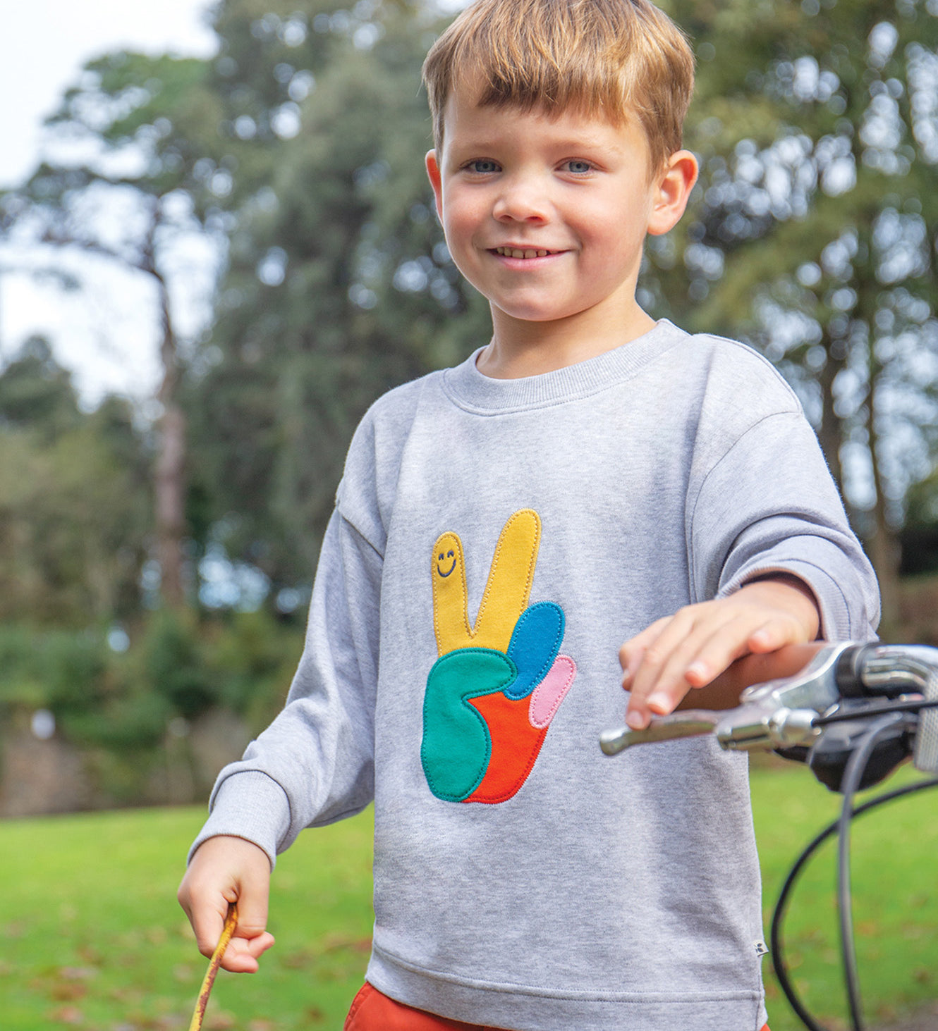 A child wearing the Frugi Owen Top - Grey Marl/Peace