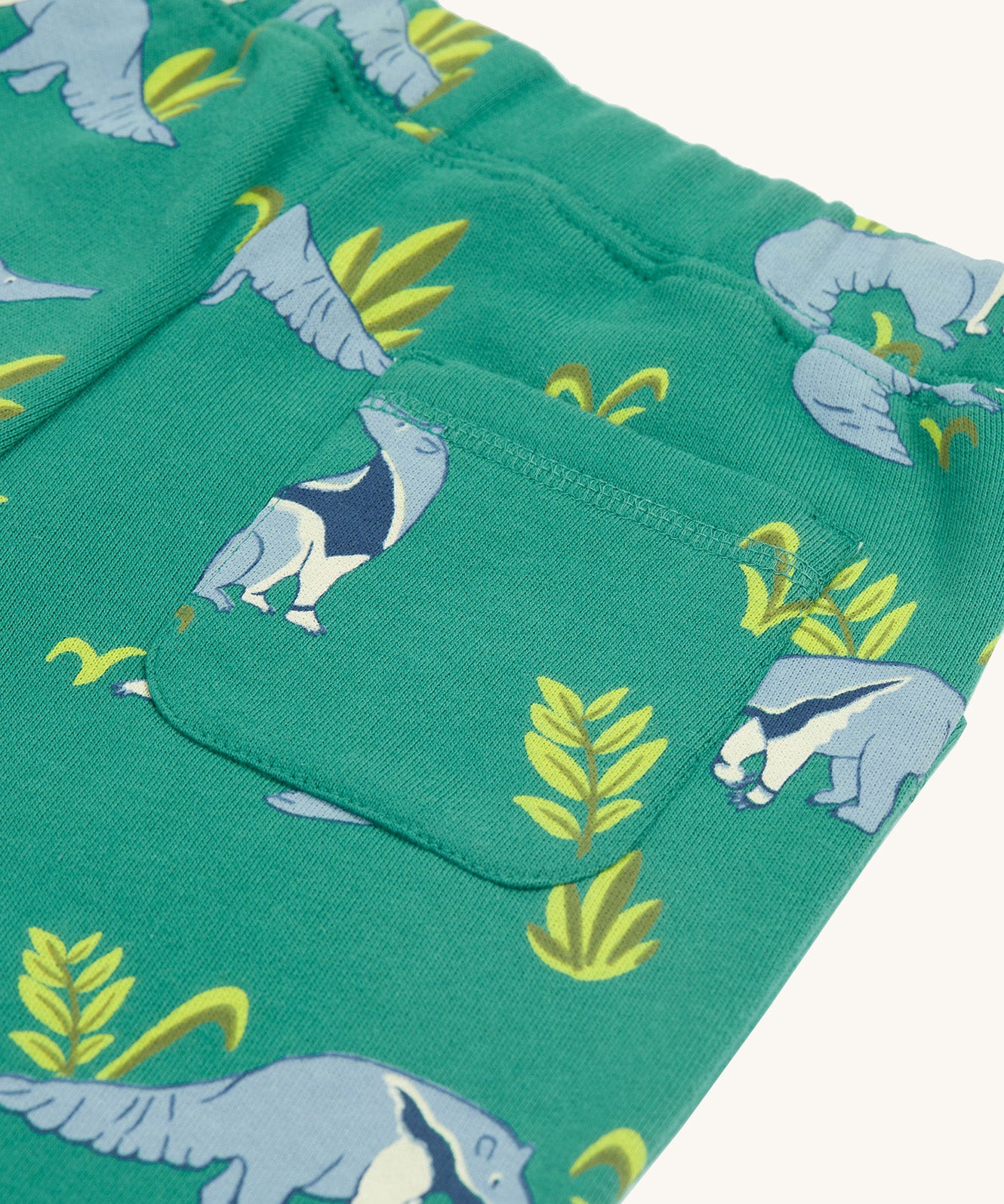 A closer look at the back pocket on the Frugi Malpas Joggers - Anteater Parade, with the repeat anteater print