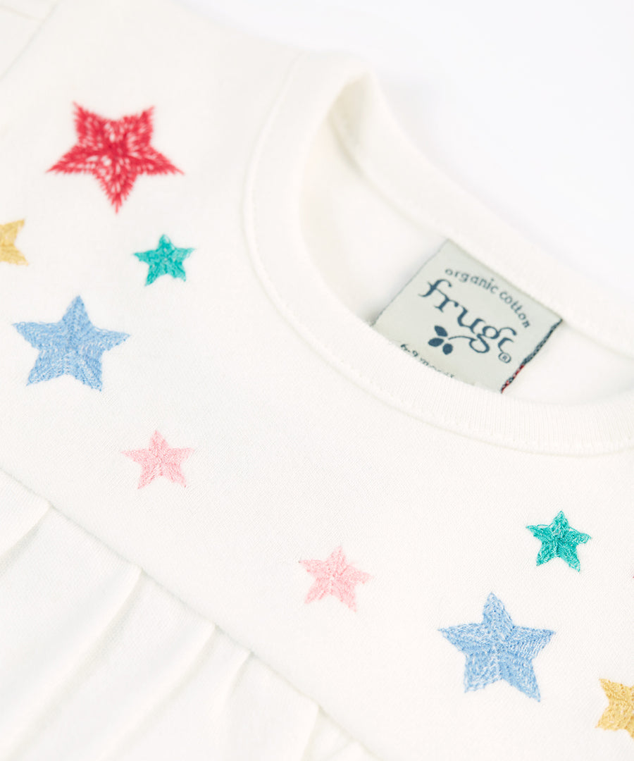 The colourful embroidered stars on the front of the Frugi Eviana Baby Body - Soft White/Stars