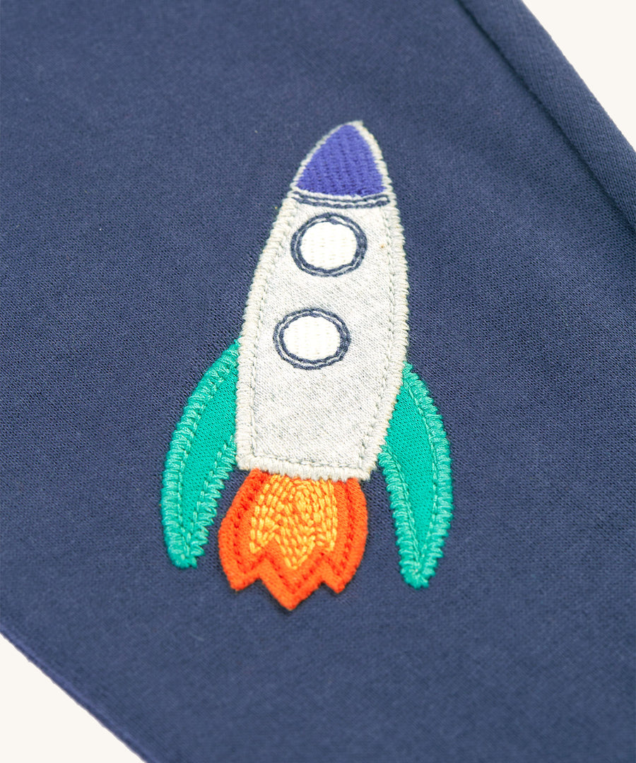 The rocket applique on the knee of the Frugi Character Crawlers - Navy Blue/Rocket