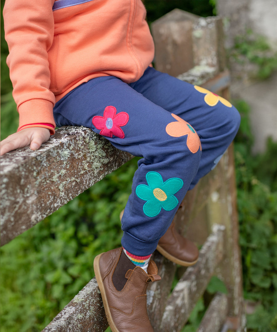 A closer look at the Frugi Perrin Parsnip Jogger - Navy Blue/Flowers, showing the flower applique details